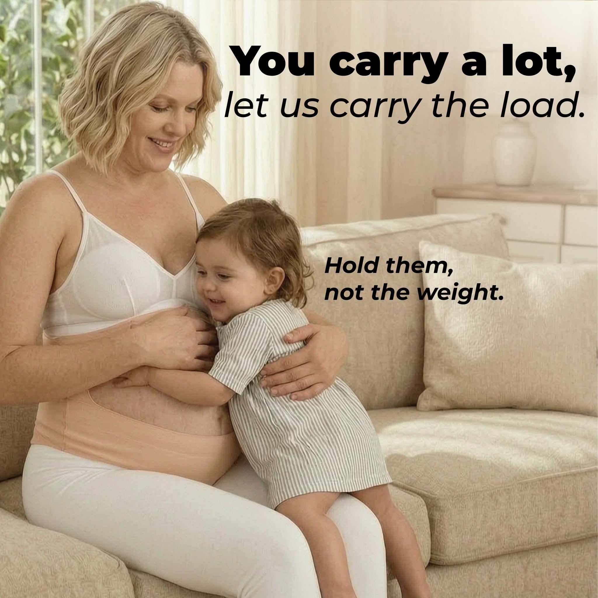 Mother wearing the belly band while holding her toddler on the sofa