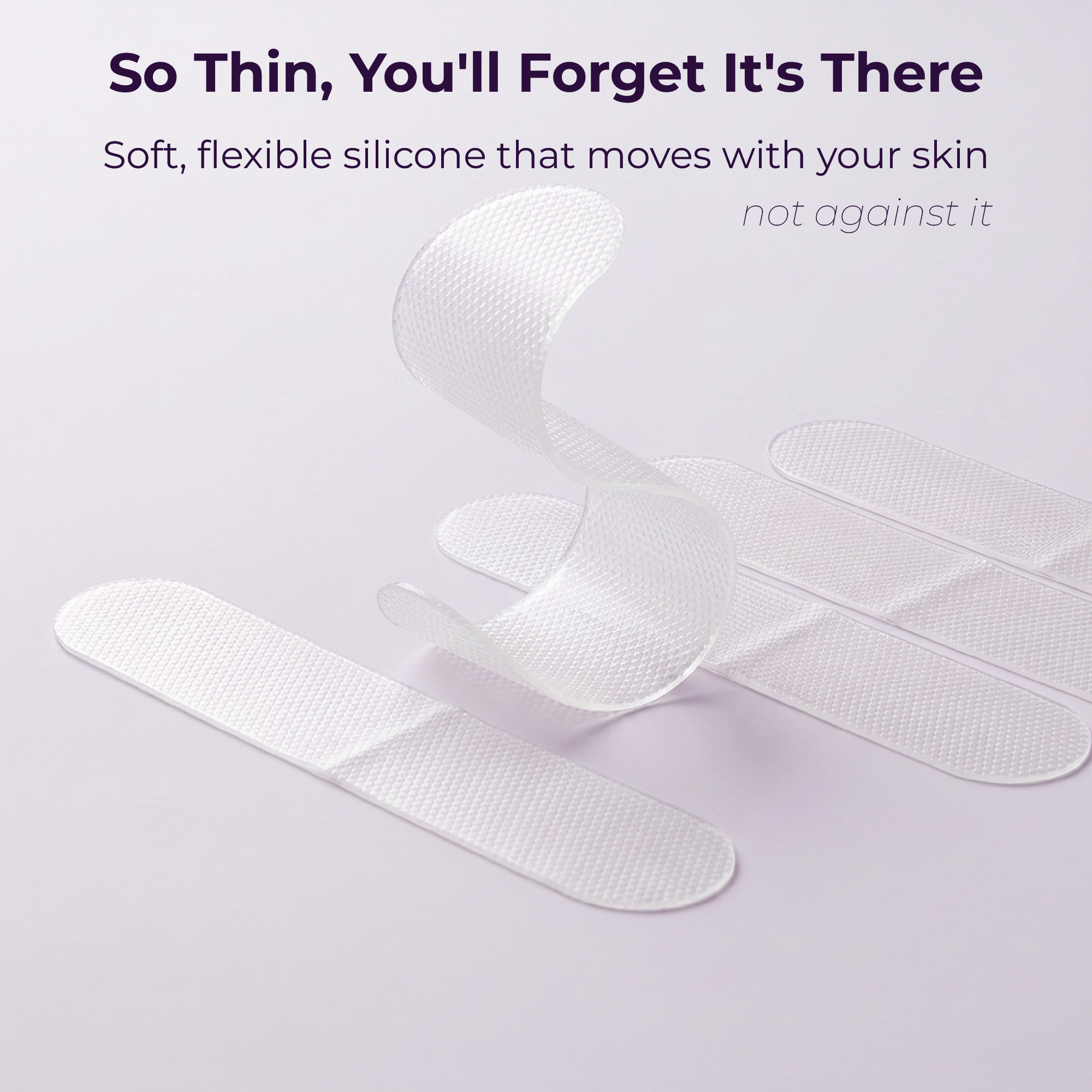 Three Momnagi silicone scar sheets curling in mid-air, showing how thin and flexible they are